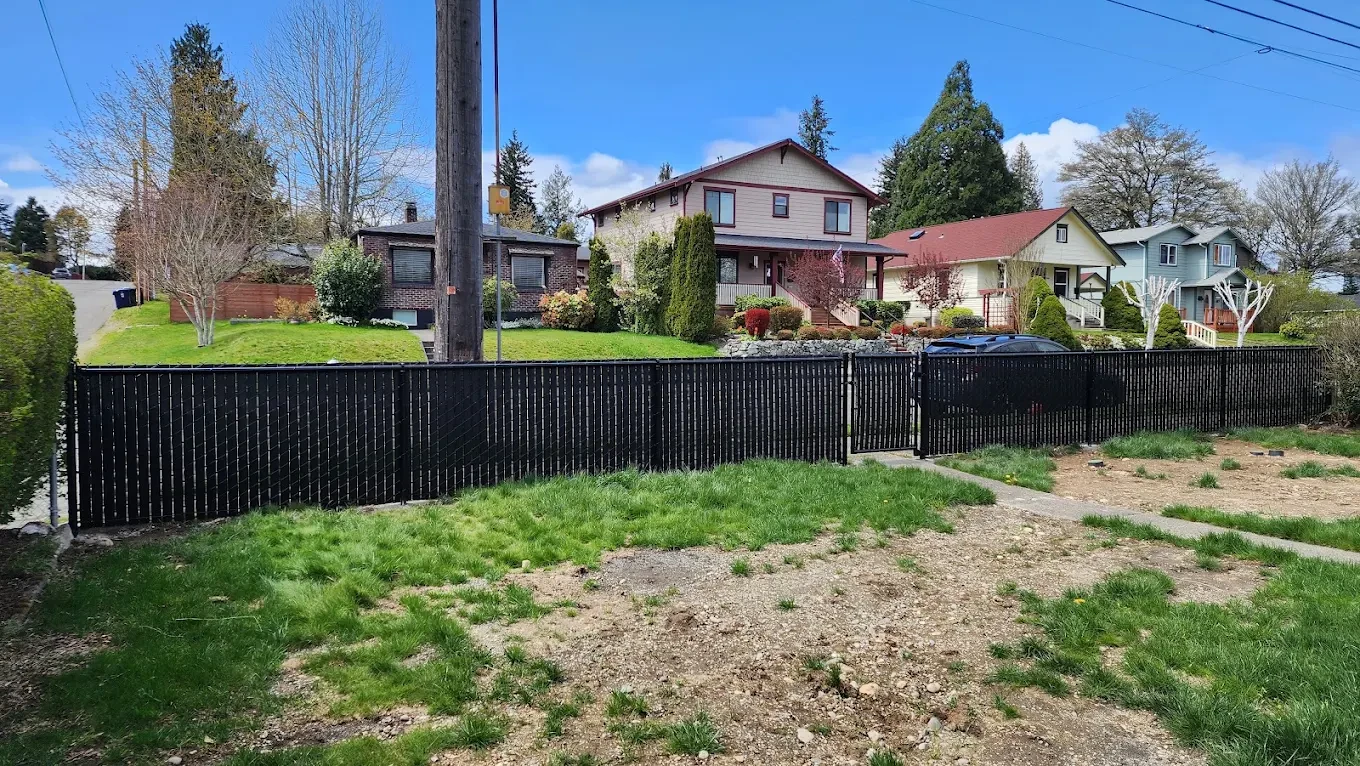 Black fence running along residential neighborhood street