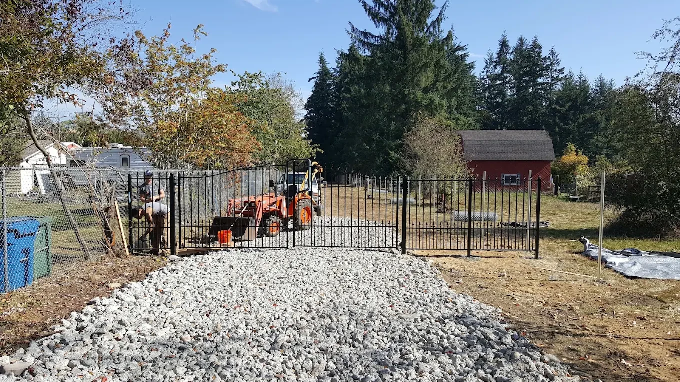 Metal fencing along gravel driveway on rural property